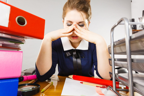 Depressed businesswoman sitting at desk