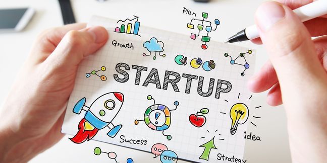 Mans hand drawing Startup concept on notebook